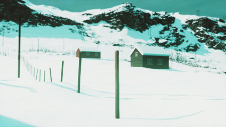 Snow blankets the ground in a serene winter scene where two small cabins stand near a fence amidst a stunning mountain backdrop. The quiet atmosphere invites reflection.の写真素材