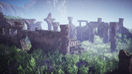 Crumbling stone structures stand in a misty landscape, surrounded by vibrant foliage and towering mountains in the distance. Nature is reclaiming the remnants of a forgotten civilization.の写真素材