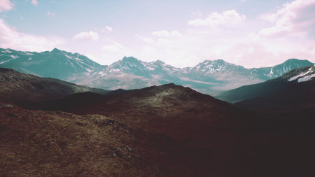 Majestic peaks rise against a colorful sky, blending earthy tones with the nights approach. The soft light enhances the rugged landscapes beauty and tranquility, inviting exploration.の写真素材