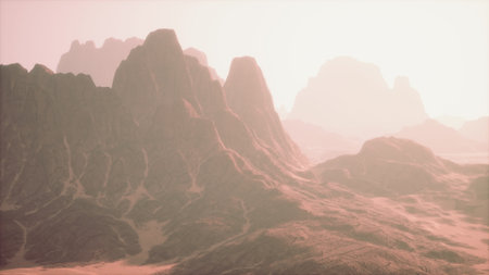 Breathtaking view of rugged mountains and valleys bathed in gentle sunlight. The warm hues create a serene atmosphere that invites exploration and reflection in this natural setting.の写真素材