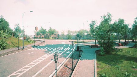 A tranquil scene captures a deserted urban street surrounded by lush trees and greenery. Sidewalks...