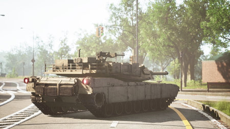 A military tank moves along a curving road in an urban area. Lush trees surround the scene, emphasizing the contrast between nature and military presence on a sunny day.の写真素材