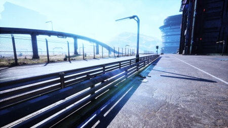A wide pathway leads through a high tech urban area with sleek buildings. Bright sunlight shines...