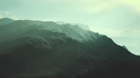 Mountains fill the scene with majestic peaks journeying into the mist. Soft sunlight touches the rugged terrain, creating an ethereal atmosphere, perfect for quiet contemplation.の写真素材