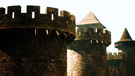 Majestic stone towers of an ancient castle stand tall against the bright blue sky. The fortification showcases intricate architecture and timeless beauty, inviting exploration and wonder.の写真素材