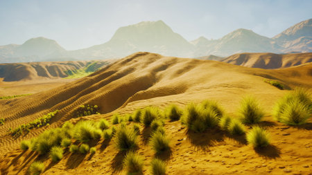 Golden sand dunes stretch under a warm sun, with sparse greenery dotting the landscape. Majestic mountains rise in the background, creating a serene and tranquil scene.の写真素材