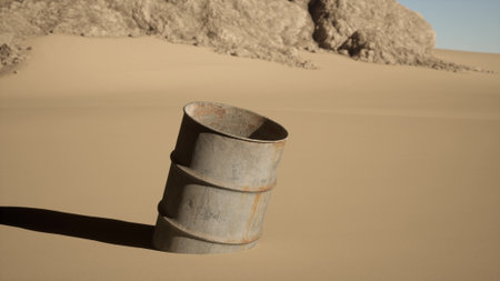 A weathered barrel leans against the desert backdrop, surrounded by rolling dunes and rocky formations. The sun casts long shadows as the wind creates a tranquil yet eerie scene.の写真素材
