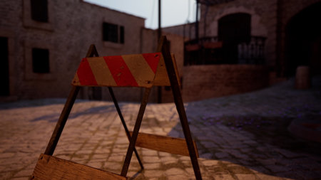 In a tranquil, ancient village, a construction barrier rests on cobblestone streets as the evening sky softly darkens. Shadows dance among the stone buildings, revealing layers of history.の写真素材