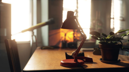 A warm glow fills a cozy workspace featuring a red desk lamp. The scene also includes a green plant...