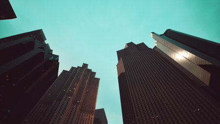 Tall buildings tower above, their reflective surfaces gleaming under a bright sky. The perspective emphasizes the grandeur of the architecture, capturing the essence of a vibrant city.の写真素材