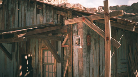 A weathered wooden cabin stands in a desert setting, illuminated by warm golden light. The antique lantern hangs from a wooden post, evoking a sense of nostalgia and tranquility.の写真素材