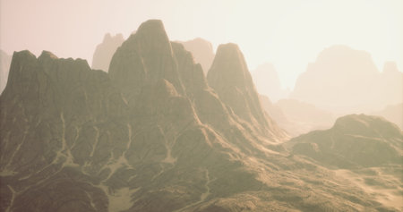 In a serene setting, majestic mountains loom, bathed in soft golden sunlight. Their rugged peaks and slopes create a breathtaking panorama, evoking a sense of calm and wonder.の写真素材