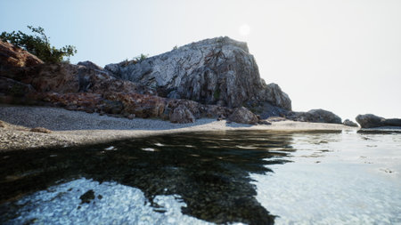 A tranquil beach surrounded by rocky cliffs. Clear water reflects the sunlight, creating a peaceful atmosphere. A perfect spot for relaxation and nature appreciation.の写真素材
