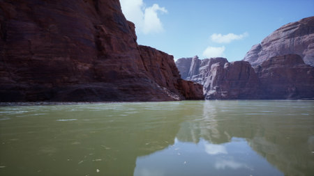 Bright sun shines down on calm waters as towering canyon cliffs rise dramatically on either side, reflecting serenity and natural beauty in an untouched landscape.の写真素材