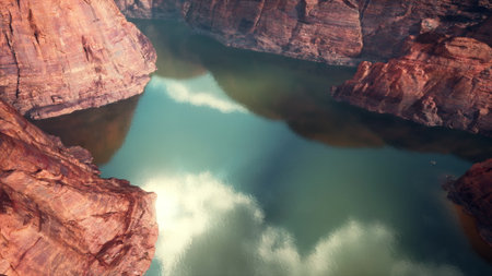 This stunning view captures the tranquil waters of a secluded canyon reflecting the colorful rock formations above.の写真素材