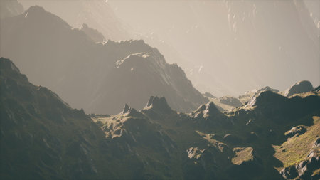 Rugged mountains stretch endlessly, bathed in warm sunlight. Soft shadows create depth, while the greenery below adds hints of life to the stunning wilderness scene.の写真素材