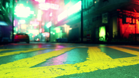 Bright neon signs illuminate a bustling street at night. The colorful glow contrasts with the wet pavement, creating a lively atmosphere in the cityâs nightlife.の写真素材
