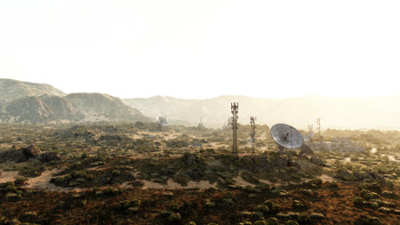 A vast desert landscape showcases towering communication towers and satellite dishes. The warm glow of sunset casts long shadows, highlighting the natural beauty alongside modern technology.の写真素材
