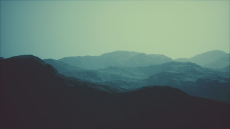 Soft hues of blue envelop the rolling mountains as twilight descends. Layers of peaks create a tranquil atmosphere, inviting reflection and peace in natures embrace.の写真素材