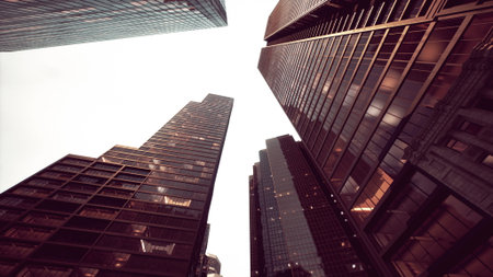 Tall glass buildings reach towards the cloudy sky, reflecting light from nearby windows. The...
