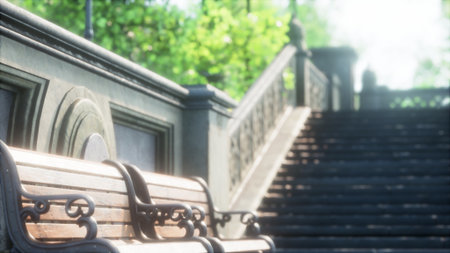 A peaceful scene unfolds in a park, where wooden benches sit beside stone steps leading through lush greenery. Soft morning light filters through the trees, creating a tranquil atmosphere.の写真素材