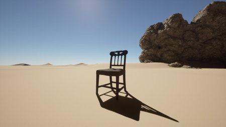 A weathered wooden chair rests solitary on golden sand, casting a long shadow in the bright sunlight. Rugged rock formations rise in the background, creating a stark contrast.の写真素材