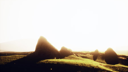 Rolling green hills rise against a bright sky as the sun begins to set. Long shadows stretch across...