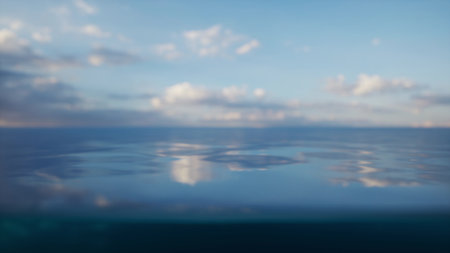 Gentle waves merge with a clear sky as clouds drift lazily during twilight. The peaceful water...