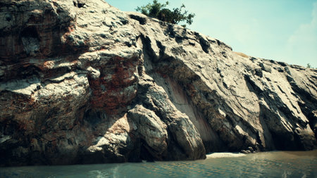 Waves gently lap at the base of rugged cliffs, with vibrant greens peeking from the rocky landscape...