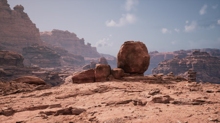 Towering cliffs and unique rock formations dominate this tranquil desert landscape under a vast blue sky. Warm sunlight casts shadows over the rugged terrain, enhancing the beauty of nature.の写真素材