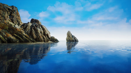 Crystal clear waters gently lap against rugged rocks under a brilliant blue sky, creating a serene landscape perfect for relaxation and contemplation by the ocean.の写真素材