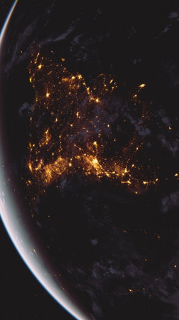 A striking view of the illuminated Earth from space at night, showcasing the glowing lights of cities and continents.の写真素材