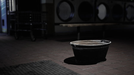 A Bucket Sitting on the Ground in the Darkの写真素材
