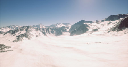 Expansive view of snow covered mountains and valleys under a bright blue sky. The pristine landscape evokes a sense of tranquility and natural beauty, showcasing untouched wilderness.の写真素材