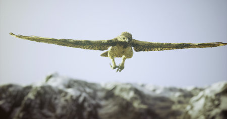 A hawk glides gracefully through the sky, its wings spread wide, against a backdrop of steep, rocky mountains under a clear blue sky. The scene captures the essence of wildlife in motion.の写真素材