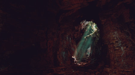 A cave with a light coming out of it