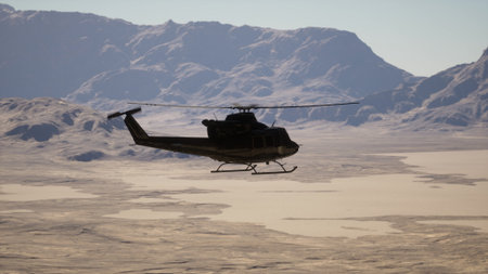 A vintage helicopter soaring over a majestic snow-covered mountain rangeの写真素材