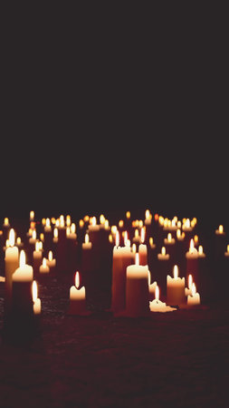 Soft flickering lights from numerous candles create a warm and inviting atmosphere in a dark space. The gentle glow enhances a sense of calm and tranquility.の写真素材