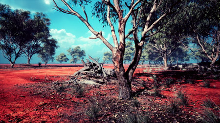 Beautiful view of a red earth landscape dotted with green trees under a clear blue sky. The tranquil scene reflects the beauty of nature, inviting peace and reflection.の写真素材