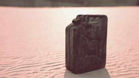 A weathered canister rests on dry, cracked ground under the fading light of sunset. The warm hues create a striking contrast against the rugged surface, evoking solitude and resilience.の写真素材
