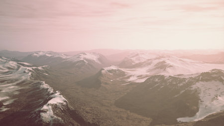 A stunning view of a mountain range at dawn, where soft sunlight gently illuminates the snow capped peaks.の写真素材