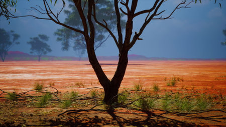 A solitary tree stands against the backdrop of a vast, dry landscape. Sunlight paints the earth...