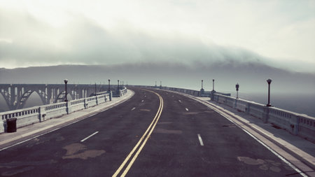 A peaceful coastal road winds along the edge of a vast ocean. Thick fog blankets the horizon, while...
