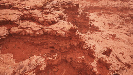 Red rock formations rise sharply under the expansive sky, revealing unique textures and layers....