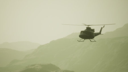 A helicopter gracefully hovers above rugged mountains shrouded in mist, illuminated by the soft glow of twilight. The serene atmosphere invites adventure amidst natures beauty.の写真素材