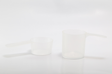 Plastic scoop used for measuring on white backgroundの写真素材
