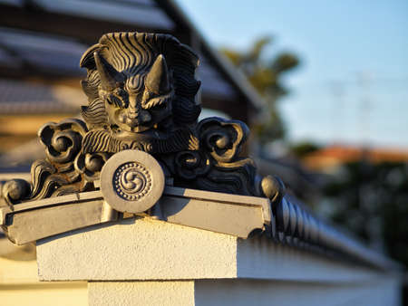 Oni tile on the wall of the templeの写真素材