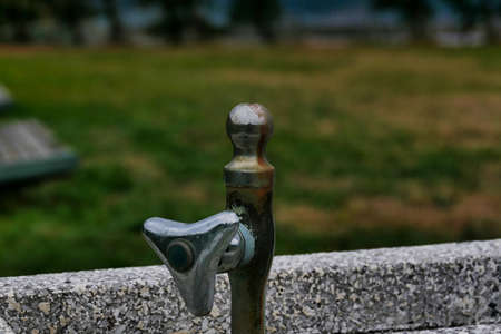 Old faucet in the park watering alleyの写真素材
