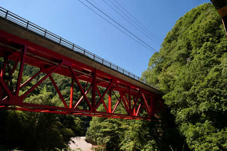 Red iron bridge just outside the tunnelの写真素材