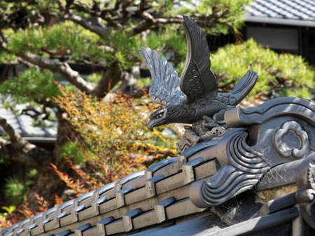 a hawk tile attached to the edge of a roof tile on a wall